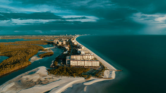 Aerial view of Bonita Beach in Bonita Springs: white sand, turquoise Gulf water and beachfront buildings