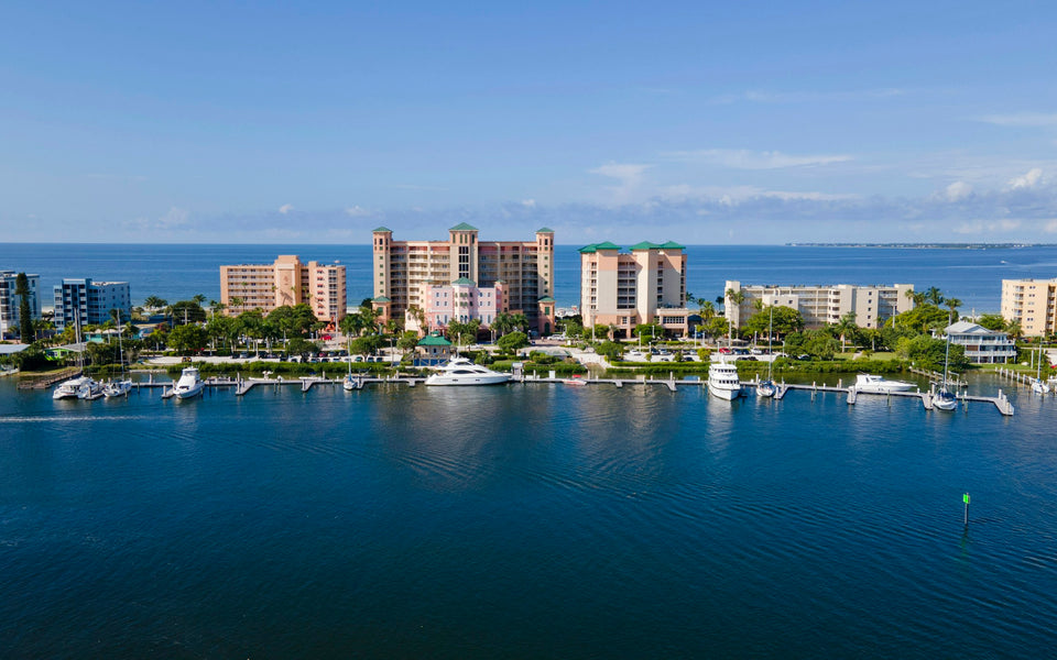 Sample small-business website we build, with a Fort Myers Beach waterfront photo as its hero: blue bay, boat docks, beachfront buildings and palm trees